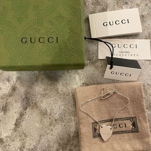 Gucci sterling silver heart bracelet with trademark